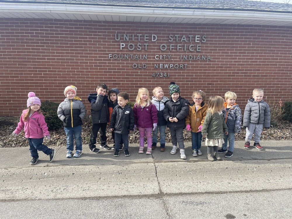 students standing in front of the post office in winter coats